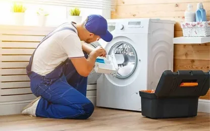 Certified GulfFix technician repairing a washing machine in a modern Dubai home